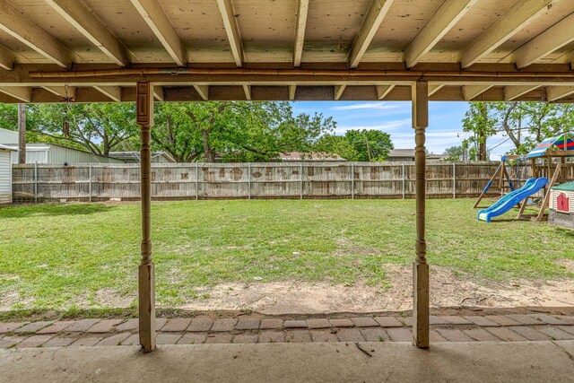 view of yard with a fenced backyard and a playground