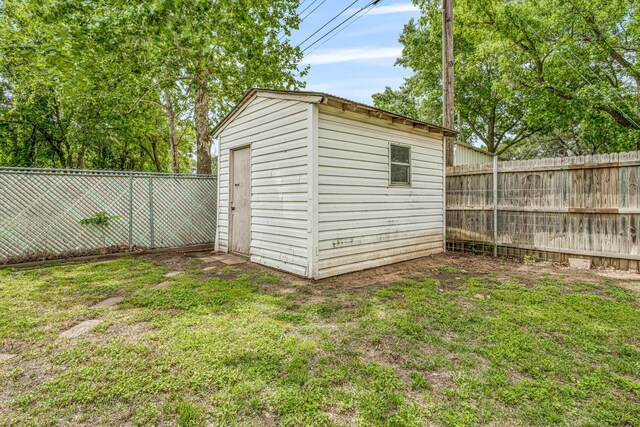 view of shed with a fenced backyard