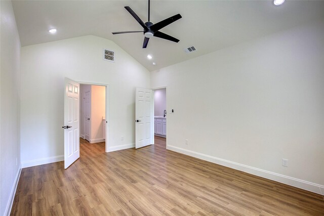 unfurnished bedroom featuring light wood-type flooring, visible vents, high vaulted ceiling, and recessed lighting