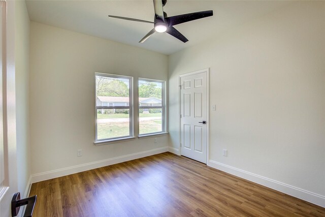 spare room with ceiling fan, baseboards, and wood finished floors