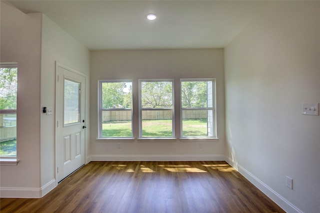 interior space with dark wood finished floors and baseboards
