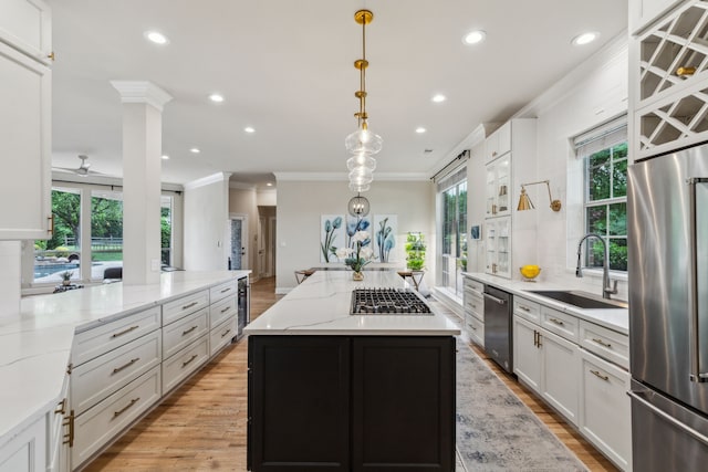 881 Saint James Ct, Fairview, TX 75069 - kitchen with appliances with stainless steel finishes, a sink, crown molding, plenty of natural light, and a center island