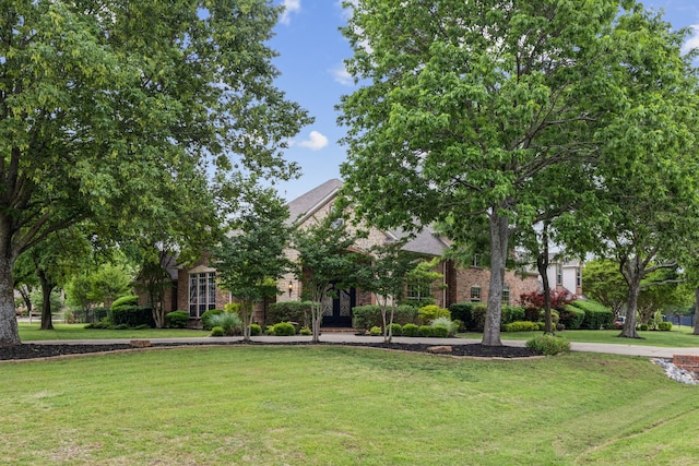 881 Saint James Ct, Fairview, TX 75069 - view of property hidden behind natural elements with a front yard and brick siding