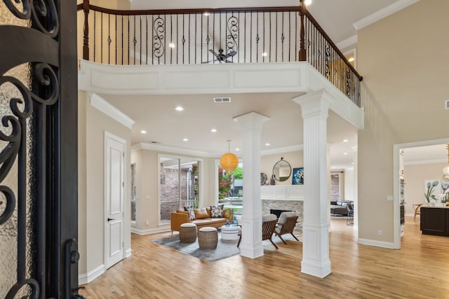 881 Saint James Ct, Fairview, TX 75069 - foyer featuring a towering ceiling, baseboards, crown molding, light wood-style flooring, and a fireplace