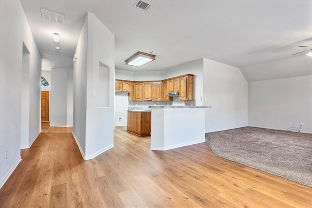 1008 Talley Ln, Frisco, TX 75033 - unfurnished living room with arched walkways, visible vents, light wood finished floors, and baseboards