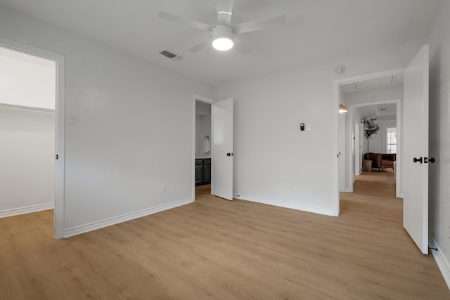 unfurnished bedroom featuring attic access, visible vents, and light wood-type flooring