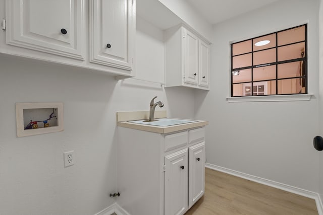 238 High Brook Dr, Richardson, TX 75080 - clothes washing area with a sink, cabinet space, hookup for a washing machine, light wood-type flooring, and baseboards