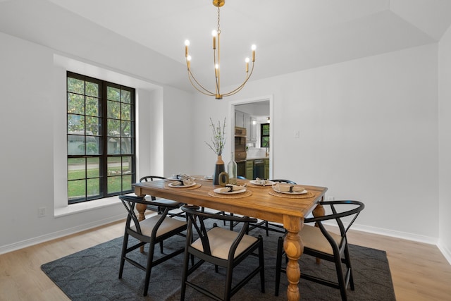 dining area with a chandelier, light wood-style floors, and plenty of natural light