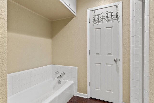 full bath featuring a garden tub and wood finished floors