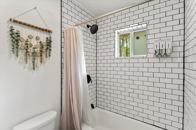 full bath featuring toilet and shower / bath combination with curtain
