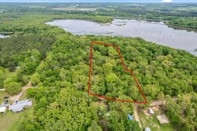 aerial view with a wooded view and a water view
