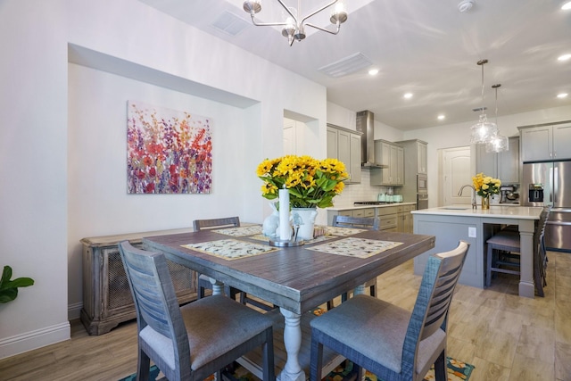 318 Waters Edge Dr, Argyle, TX 76226 - dining space featuring light wood finished floors, visible vents, an inviting chandelier, and recessed lighting