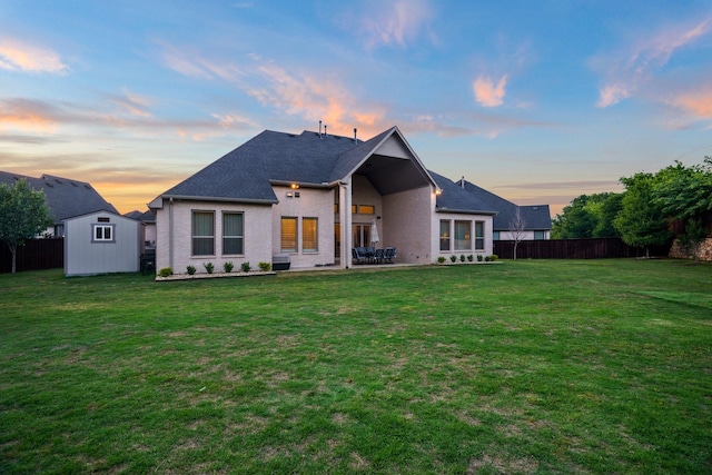 318 Waters Edge Dr, Argyle, TX 76226 - back of house with fence, an outbuilding, a storage shed, and a yard
