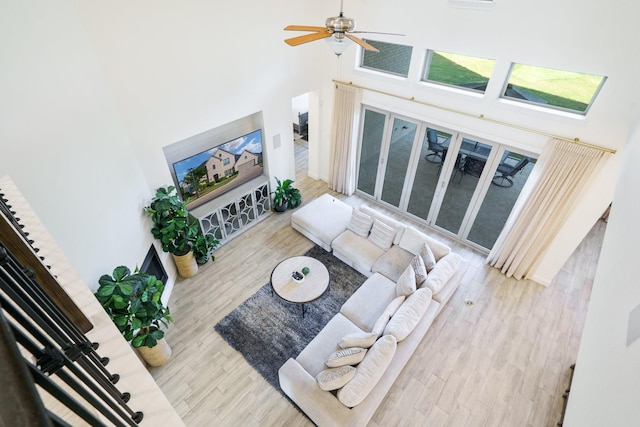 318 Waters Edge Dr, Argyle, TX 76226 - living area featuring wood finished floors, a high ceiling, and a ceiling fan