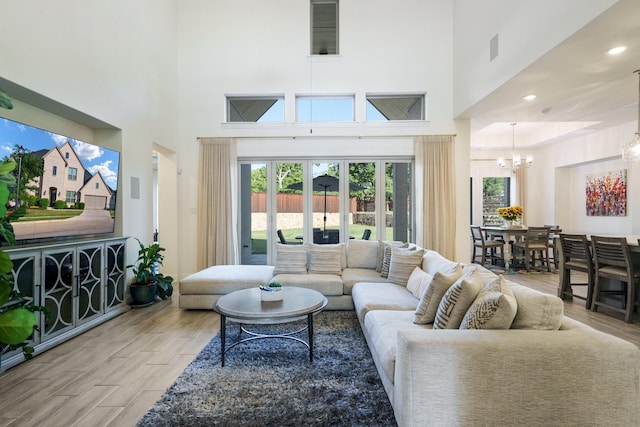 318 Waters Edge Dr, Argyle, TX 76226 - living area with a high ceiling, wood finished floors, and a chandelier