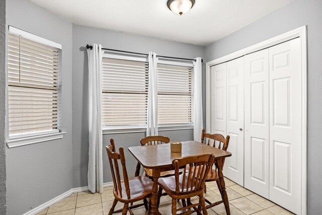 dining area featuring baseboards and light tile patterned floors