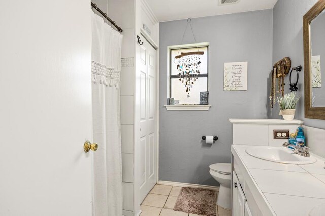 bathroom with vanity, baseboards, toilet, tile patterned flooring, and visible vents