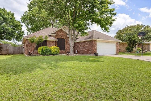 ranch-style home with brick siding, fence, concrete driveway, and a front yard