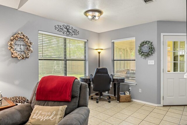 home office featuring baseboards and light tile patterned flooring