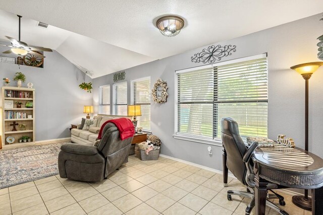 office with lofted ceiling, a ceiling fan, baseboards, and light tile patterned flooring