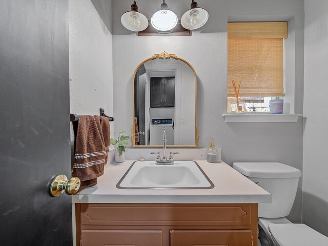 half bathroom with vanity and toilet