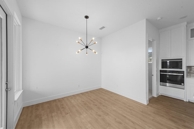 3541 Wardie Pl, Frisco, TX 75033 - unfurnished dining area with baseboards, a chandelier, visible vents, and light wood-style floors