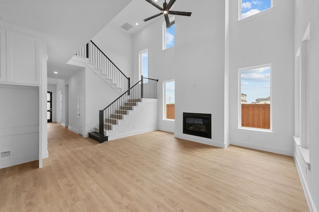 3541 Wardie Pl, Frisco, TX 75033 - unfurnished living room with a wealth of natural light, a towering ceiling, and visible vents
