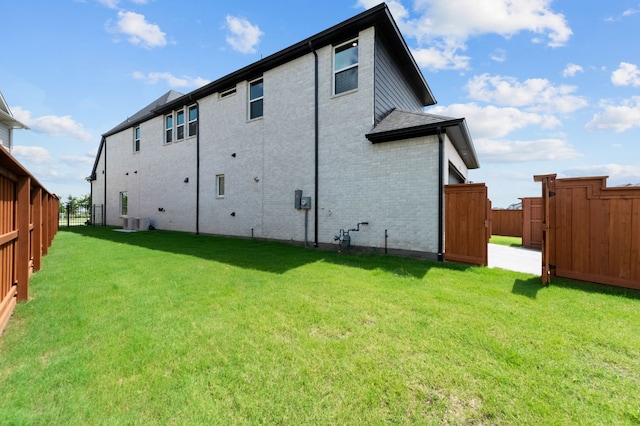 3541 Wardie Pl, Frisco, TX 75033 - back of house with a fenced backyard, brick siding, and a yard
