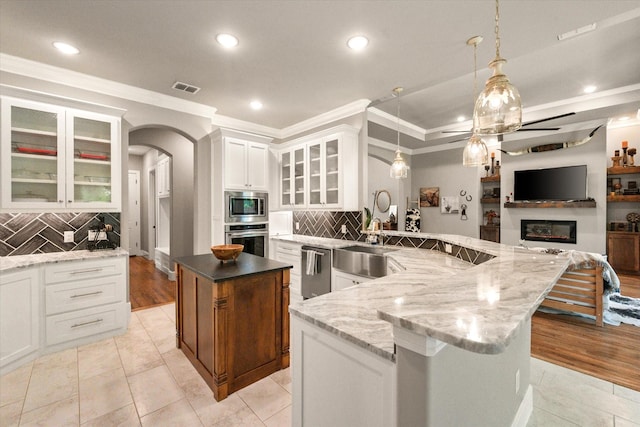 212 Rock Tree Ct, Mansfield, TX 76063 - kitchen with stainless steel appliances, crown molding, open floor plan, a center island, and backsplash