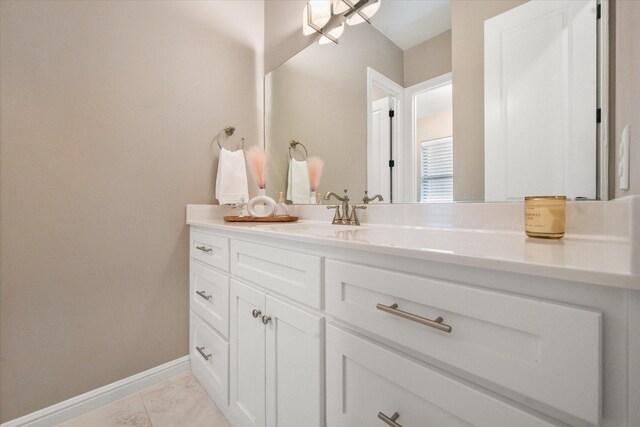 bathroom featuring baseboards, tile patterned flooring, and vanity