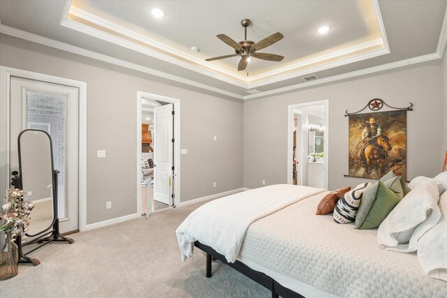 bedroom with light colored carpet, crown molding, visible vents, and a raised ceiling