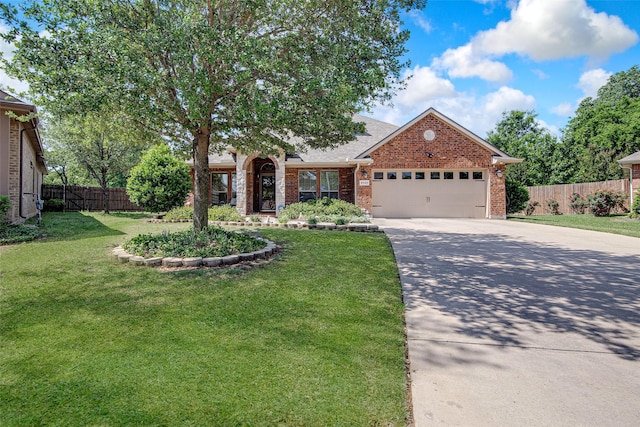 view of front facade with concrete driveway, fence, brick siding, a garage, and a front yard