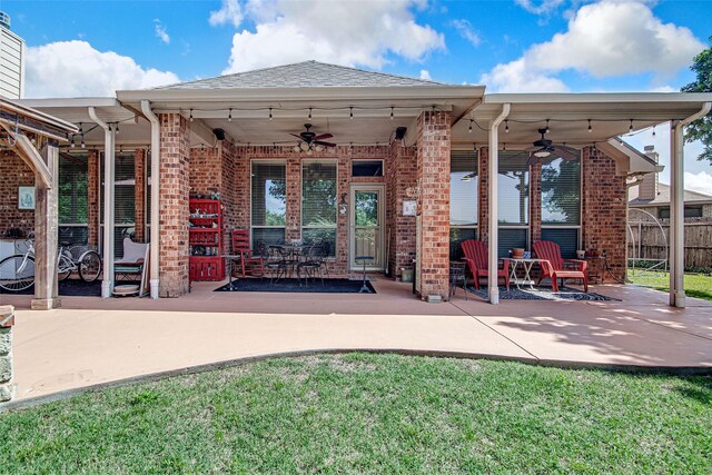 back of property featuring brick siding, a ceiling fan, and a patio