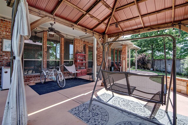 view of patio / terrace featuring ceiling fan and fence