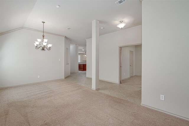 spare room with light carpet, visible vents, an inviting chandelier, lofted ceiling, and light tile patterned floors