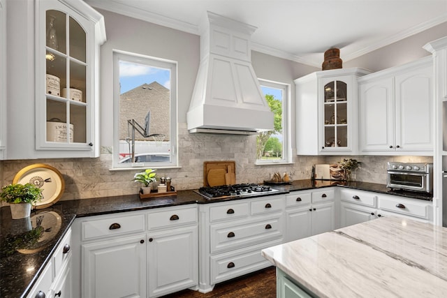 kitchen featuring white cabinets and custom exhaust hood