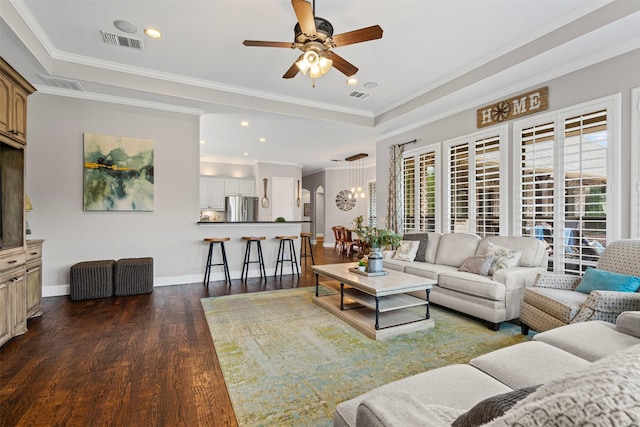 living area with wood finished floors, visible vents, and a ceiling fan