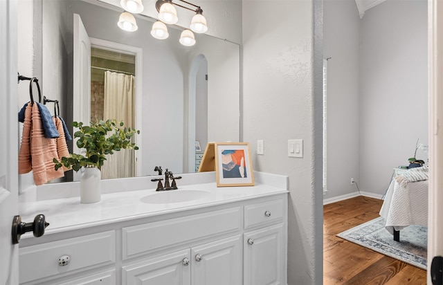 full bath featuring vanity and wood finished floors