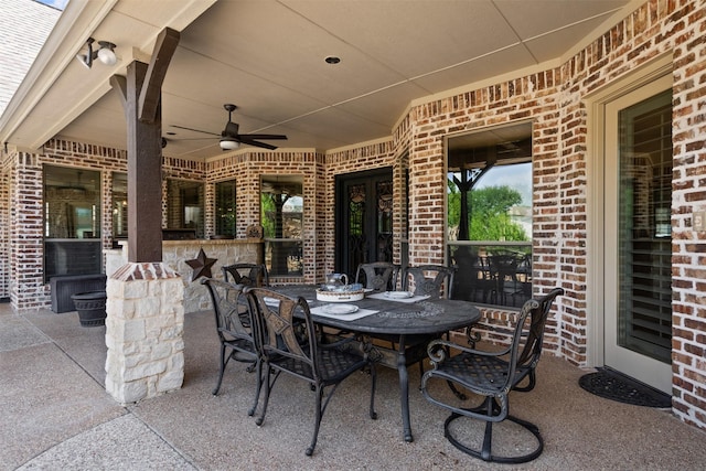 view of patio / terrace with a ceiling fan, outdoor dry bar, and outdoor dining space