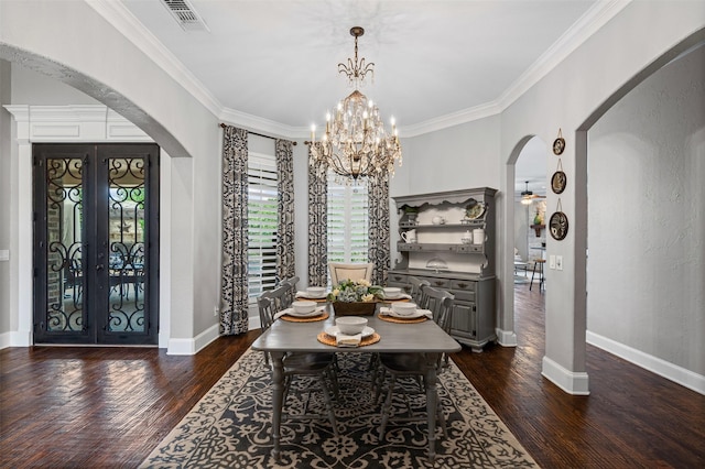 dining area featuring dark wood-style floors, arched walkways, crown molding, and visible vents