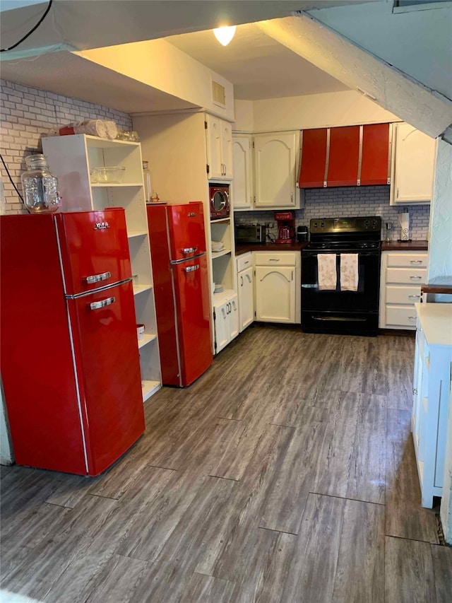 242 Club Park Ct, East Tawakoni, TX 75472 - kitchen with open shelves, freestanding refrigerator, black / electric stove, and dark wood-style floors