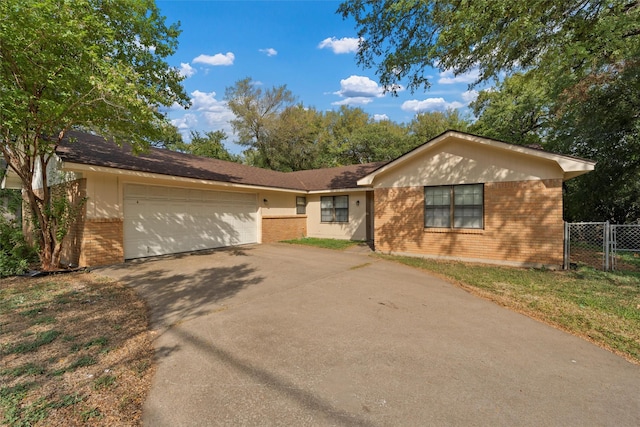 single story home featuring fence, concrete driveway, brick siding, and a garage