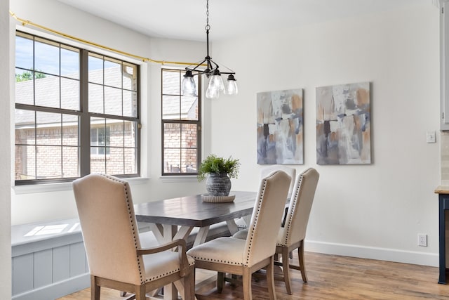 32 Royal Oaks Cir, Denton, TX 76210 - dining area with a chandelier, light wood-style flooring, and baseboards