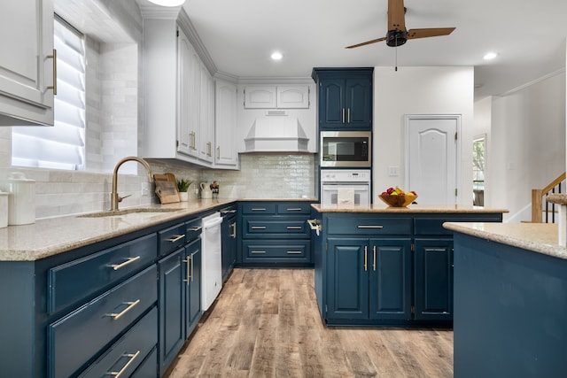 32 Royal Oaks Cir, Denton, TX 76210 - kitchen with a sink, white appliances, blue cabinets, and recessed lighting