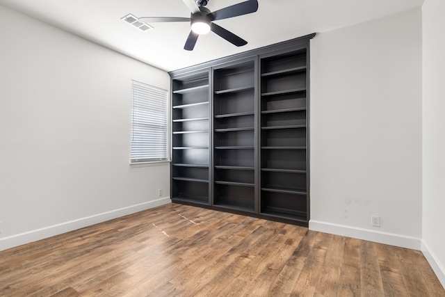 32 Royal Oaks Cir, Denton, TX 76210 - unfurnished bedroom featuring baseboards, wood finished floors, and a ceiling fan
