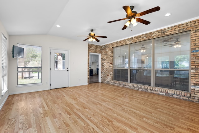 32 Royal Oaks Cir, Denton, TX 76210 - unfurnished living room featuring wood finished floors, brick wall, healthy amount of natural light, ceiling fan, and recessed lighting