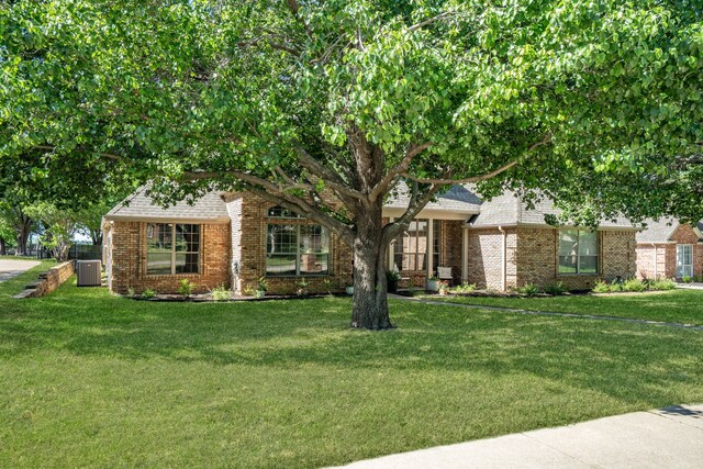32 Royal Oaks Cir, Denton, TX 76210 - view of property hidden behind natural elements with brick siding, a front yard, and cooling unit