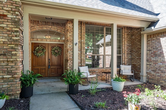 32 Royal Oaks Cir, Denton, TX 76210 - entrance to property featuring a porch, brick siding, and a shingled roof