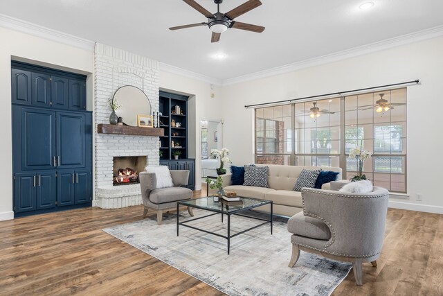 32 Royal Oaks Cir, Denton, TX 76210 - living room with ceiling fan, ornamental molding, wood finished floors, a brick fireplace, and built in shelves