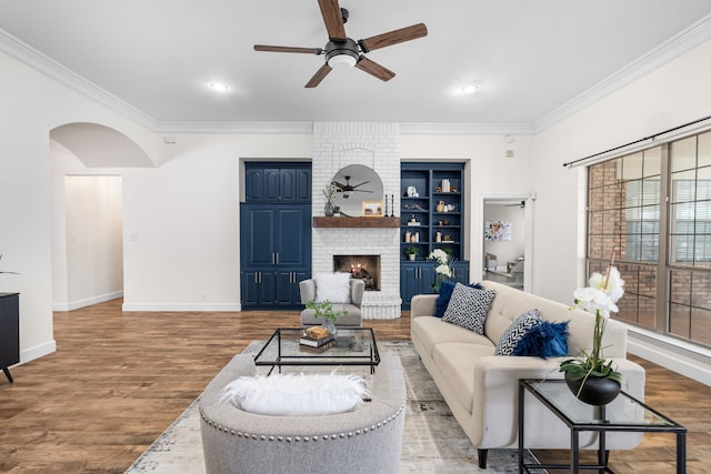 32 Royal Oaks Cir, Denton, TX 76210 - living room featuring a ceiling fan, ornamental molding, arched walkways, wood finished floors, and baseboards
